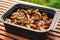 closed grill container filled with grilling mushrooms