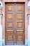 Closed grunge brown wood old door with convex rectangles as decoration