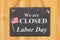 We are closed Labor Day hanging chalkboard sign with American flag