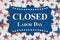 Closed Labor Day sign with USA stars and stripes flags