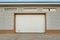 Closed light beige automatic garage doors for private house garage