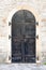 Closed metal door with stone wall on ancient fortress