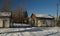 Closed metal gate with stop sign and guard houses in sunny winter day. Forgotten, abandoned ghost town Skrunda, Latvia.