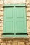 Closed, pair of, colorful, green, wood, window shutters, on house in Sablet, France