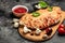 Closed pizza calzone with vegetables, herbs and spices on a dark background, italian calzone vegetarian pizza, Food recipe