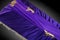 Closed purple coffin covered with elegant cloth on gray background. coffin close-up with gold flowers.