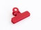 Closed red plastic medium size clothespin for plastic bags isolated on a white background