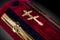 Closed red velvet coffin covered with cloth isolated on gray background. coffin close-up with gold Church cross.