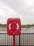 A closed red and white safety buoy box at the seaside seafront d