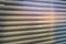 Closed shutters macro shot. Jalousie background. Sunlight through horizontal blinds