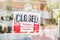Closed sign on door entrance cafe restaurant or business office store is Temporarily closed due to Coronavirus COVID-19