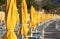 Closed umbrellas and chairs on a bathing