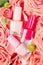 Closed unbranded bottles with nail polish. Colourful glass tubes with different lacquers. Floral background. Manicure and pedicure
