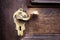 Closed up - Ancient golden keyhole for security on wooden door