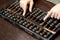 Closed up of business woman hand that calculate with wood abacus