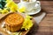Closed up delicious homemade moon cake on wooden plate over blur tea cup and chrysanthemum flower
