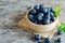 Closed up fresh blueberry fruit with green leaf