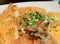 Closed up fried oysters with crispy omelette topped with chopped spring onion