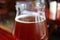 Closed up a glass of ruby color chilled craft beer