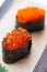 Closed up Ikura Salmon Roe Sushi with Tobiko Flying Fish Roe Sushi from Sushi Set on the Stone Plate.