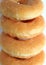 Closed up stack of sugar-glazed Donuts, vertical photo for background