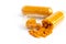 Closed up turmeric powder in plastic capsule on white background