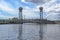 Closed vertical lift bridge with moving train and pregolya river view