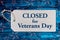 Closed for Veterans day sign on silver tag