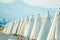 Closed white umbrellas on the beach