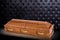 Closed wooden brown sarcophagus isolated on gray luxury background. casket, coffin on royal background.