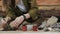 Closedup of woman`s hands gardener pours the soil with a shovel into a new ceramic pot for transplanting houseplant on