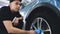 Closely shown as a professional worker polishes the transport car body using a polishing tool machine. Concept from: Auto serv