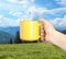 Closeness to nature. Woman holding cup in mountains, closeup