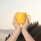 Closeness to nature. Woman holding cup in mountains, closeup