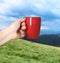 Closeness to nature. Woman holding cup in mountains, closeup