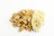 Closep of tasty cornflakes and pieces of banana on the white surface