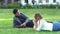 Closer to nature. couple feel free and lie on green grass in the city park. Media. Side view of man and woman friends or