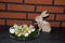 Closer view on easter eggs and a easter bunny in front of a brick wall