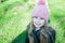 Closesup portrait little girl in hat smile against green grass