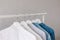 Closet, clothes hanging on hangers, stylish closet selection on a rail in the living room,