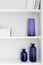 closet shelves with vases and books closeup in colors very peri