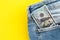 Closeup of  100 dollar bill sticking out from jeans pocket. American banknote. Flat lay