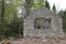 Closeup of 100-year-old stone ruins of a forgotten lodge surrounded by greenery