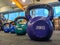 Closeup of 20 kilogram kettlebell round shaped in a ball dumbbell for bodybuilding and exercise with other weights in the