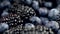 Closeup 4k dolly footage of camera moving over heap of fresh blackberry and blueberry. Perfect abstract backdrop for