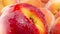 Closeup 4k dolly video of lots of fresh ripe peaches and nectarines. Perfect abstract backdrop for organic food and