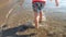 Closeup 4k footage of little toddler boy feet walking in sea on the beach