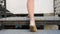 Closeup 4k video of camera following female feet in ballet flats and pantyhose walking up the stone stairs on city