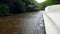 Closeup 4k video of rain water droplets falling on the motorboat sailing on river at mangrove forest