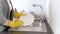 Closeup 4k video of young woman in yellow rubber gloves washing dishes on kitchen